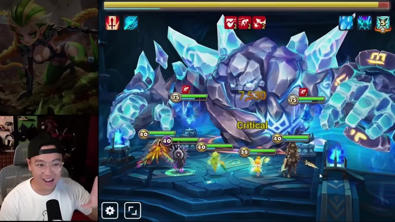 A fantasy battle screen shows several monsters or heroes fighting a large icy crystal monster while a streamer webcam overlay appears on the left.