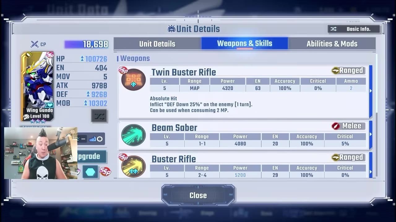 The Unit Details screen for Wing Gundam shows the Weapons & Skills tab with Twin Buster Rifle, Beam Saber, and Buster Rifle listed.