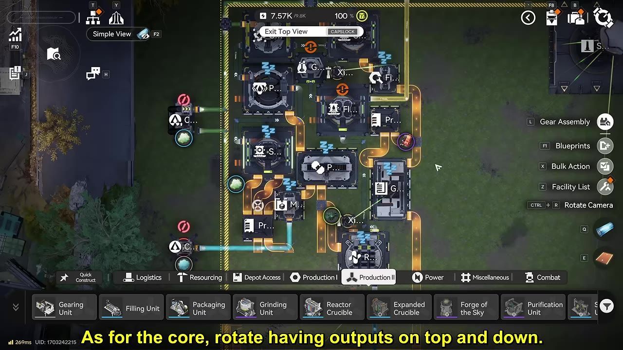 A factory layout screen shows several connected production machines inside a bordered build area, with orange and blue conveyor or pipe lines linking inputs and outputs.
